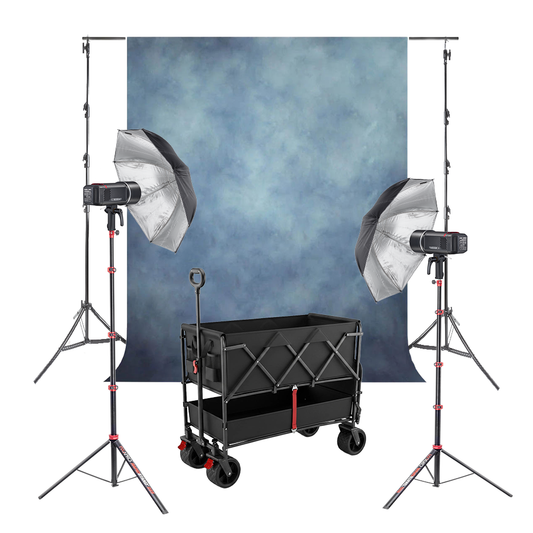 A-030429 Complete Kit. Blue textured background, 2 Godox AD600BMII, 2 Black/Silver Umbrellas, 2 Pixapro Rapid Stands, and a Pixapro Beach Cart