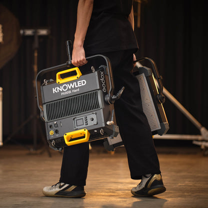 GODOX KNOWLED P600Bi Bi-Colour Hard Light LED Panels being carried by a lighting assistant