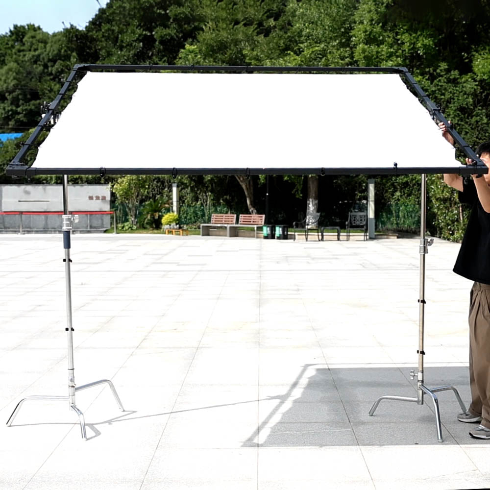 PiXAPRO Heavy-Duty Butterfly Frame Sun Diffuser Panel mounted to two C-Stands in an outdoor location (C-Stands are NOT included)