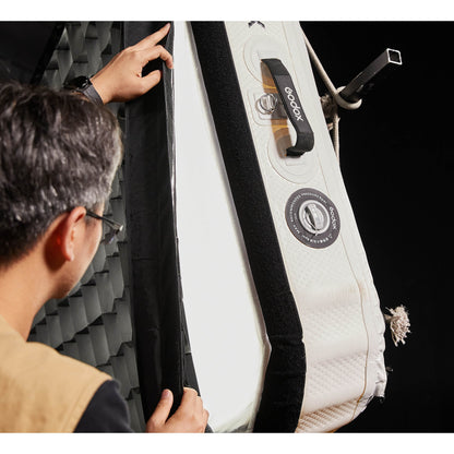 Gaffer attaching a grid to a Godox KNOWLED AM1600R-88K 8'x8' Inflatable RGB LED Light Mat