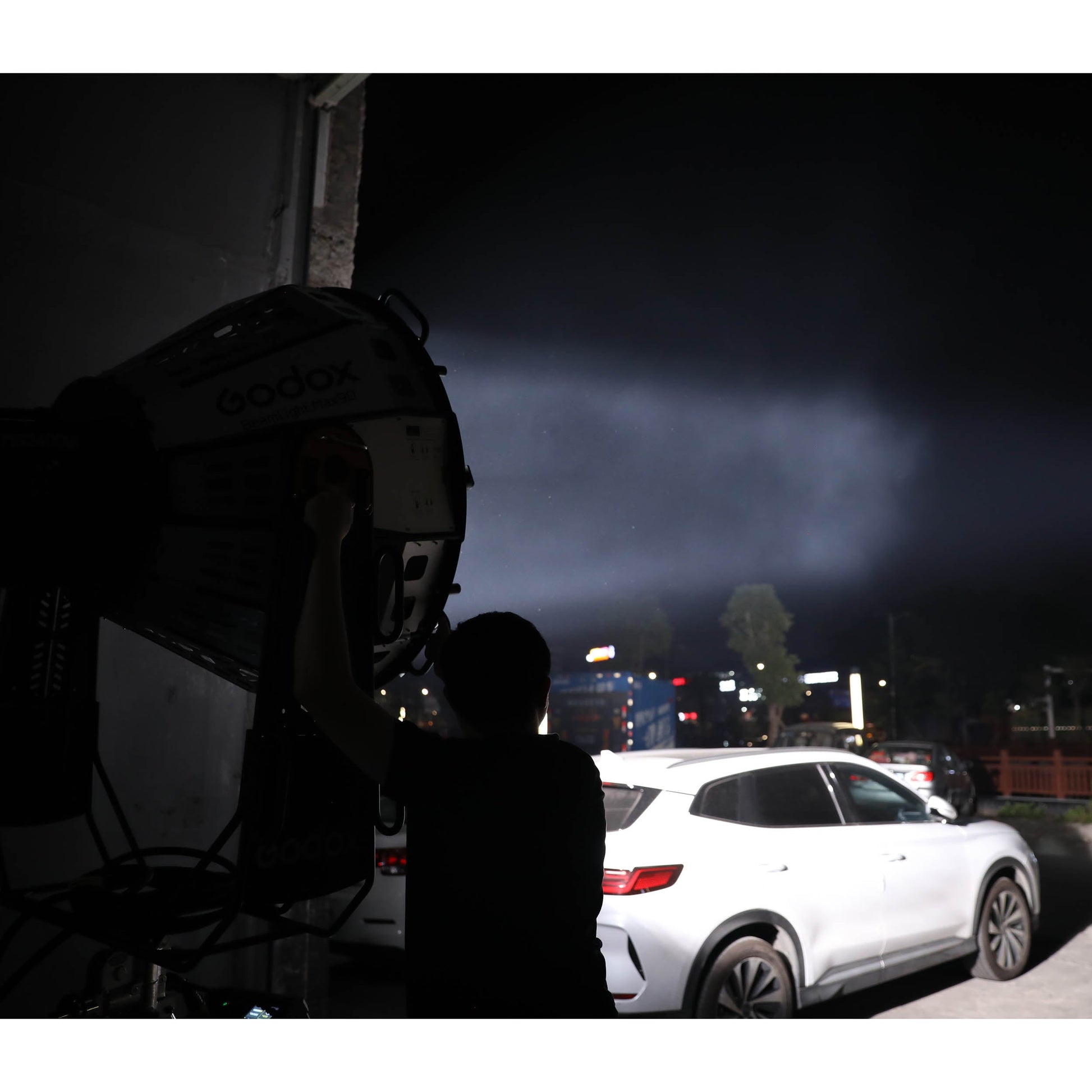 Godox BeamLight Max90 Cinema-Grade parallel-Beam Reflector being used to illuminate a car
