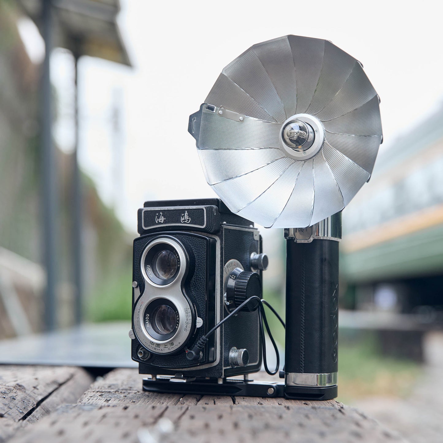 Godox FB01 Camera Mount Flash Bracket with a LUX Master flash and an old twin-lens reflex camera mounted to it