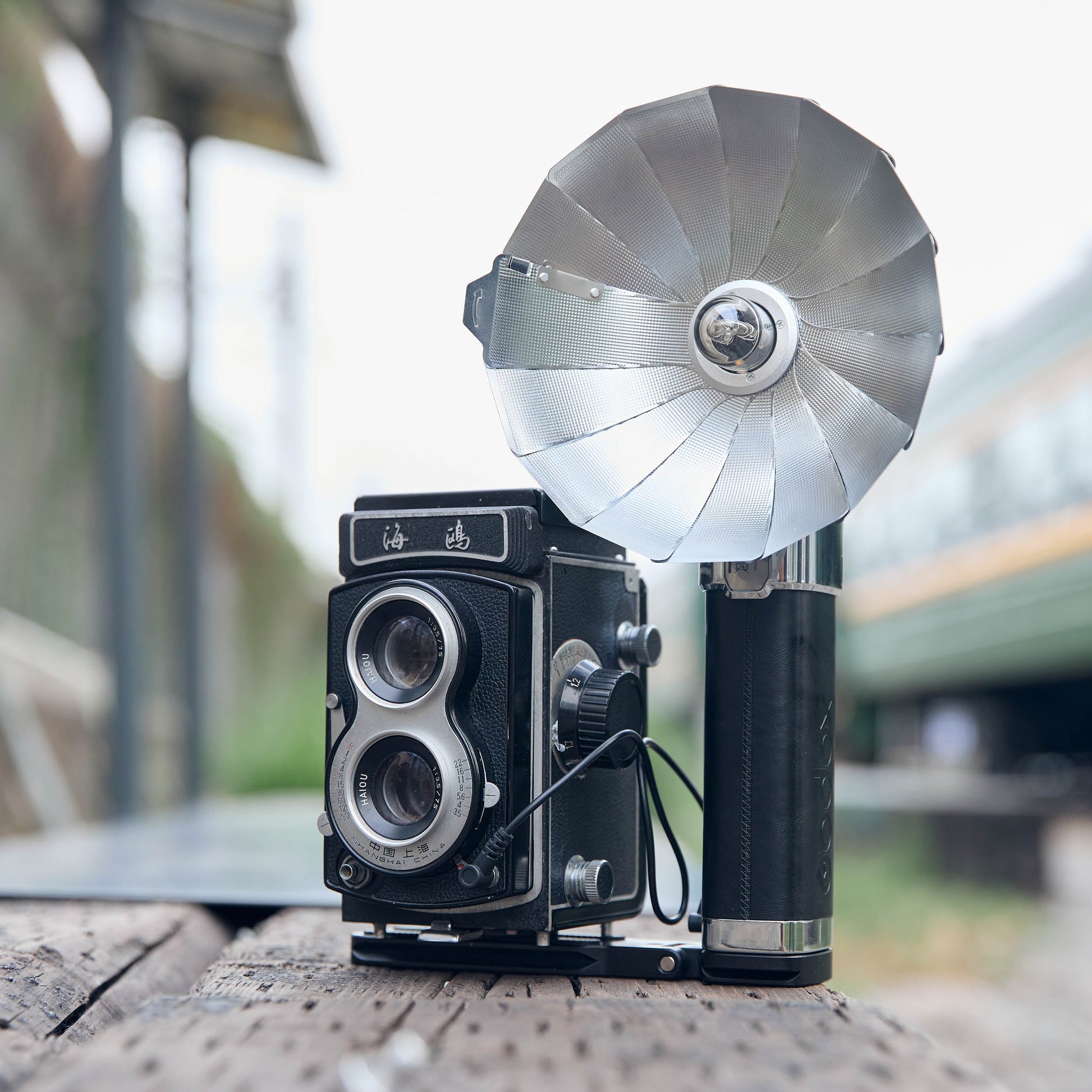 Godox FB01 Camera Mount Flash Bracket with a LUX Master flash and an old twin-lens reflex camera mounted to it