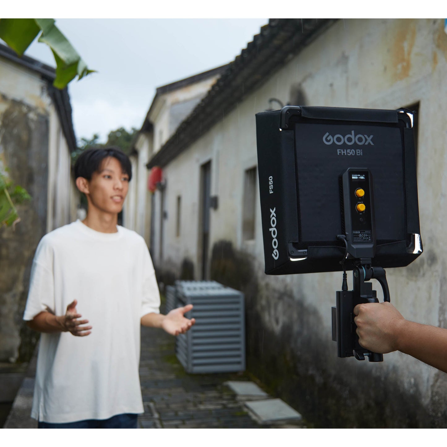 Godox FH50Bi Flexible Bi-Colour LED Light Panel being used outdoors to illuminate their subject's face