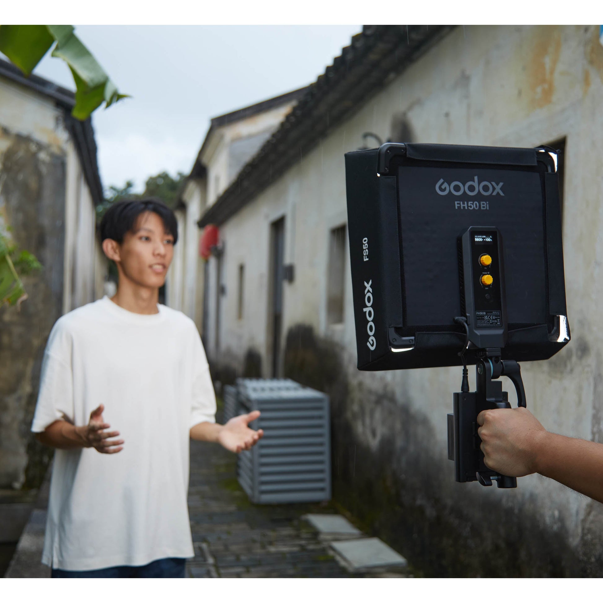 Godox FH50Bi Flexible Bi-Colour LED Light Panel being used outdoors to illuminate their subject's face