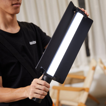 Godox LC500mini Bi-Colour LED Light Stick being held by a lighting assistant