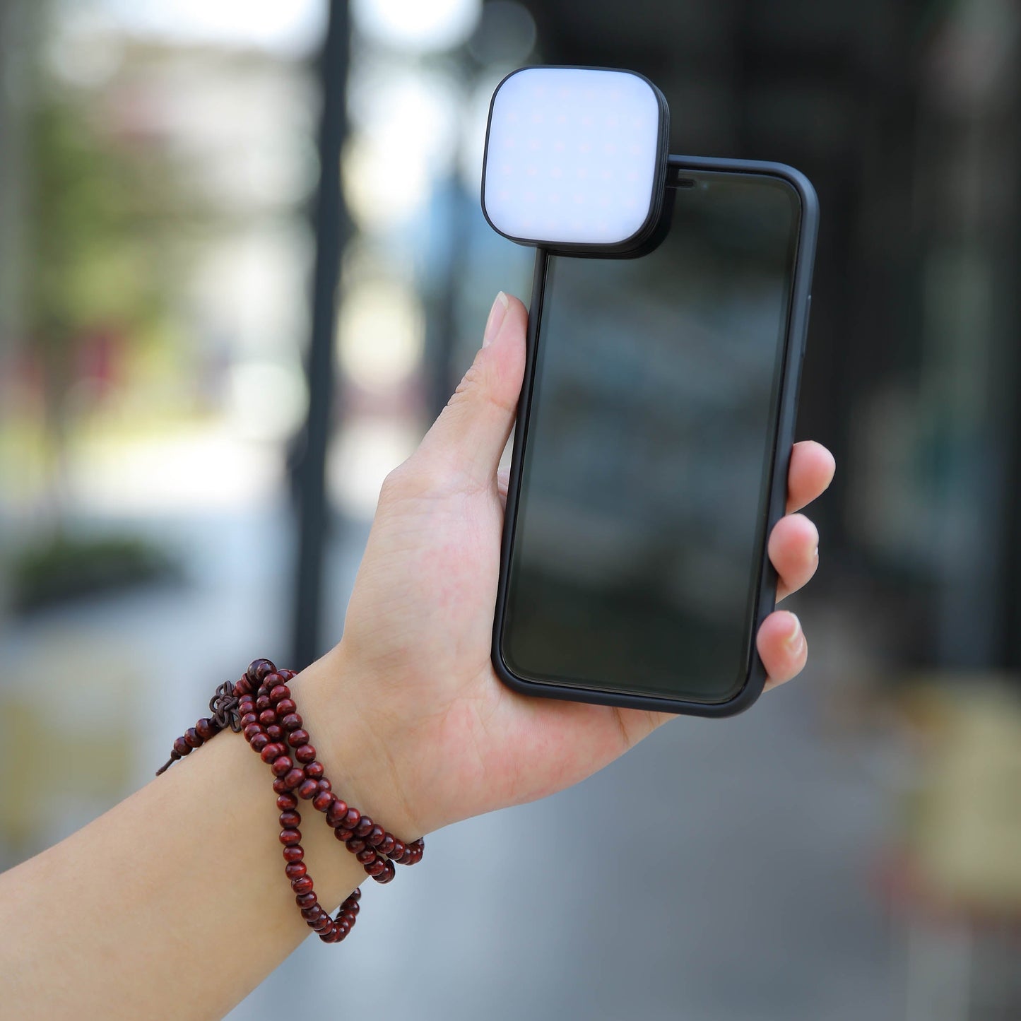 GODOX LEDM32 Clip-On Smartphone LED  Light Front View mounted to a smartphone held in a person's hand