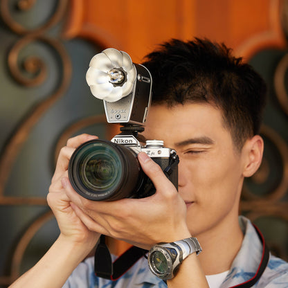 Man taking a photograph using the Godox Lux Cadet