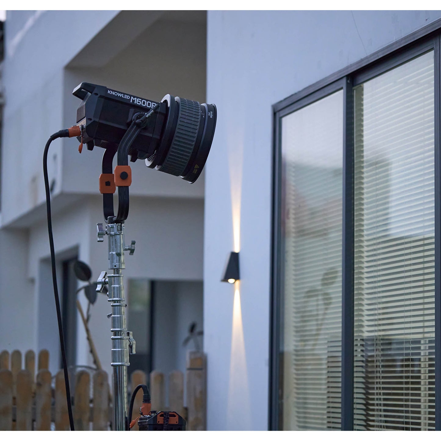 GODOX KNOWLED M600R RGBWW COB LED STUDIO LIGHT BEING USED TO ILLUMINATE A SCENE FROM OUTDOORS