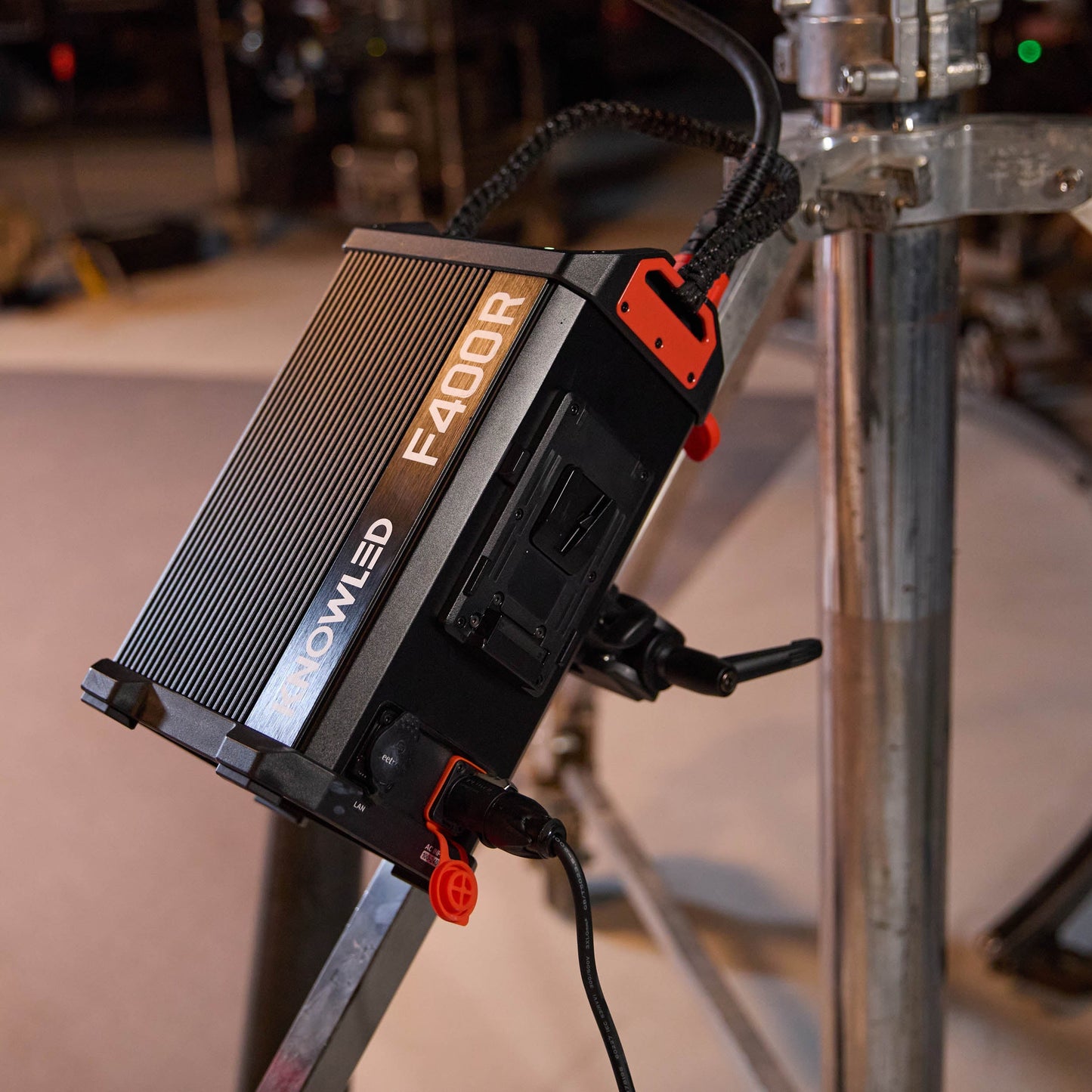 A Godox PC01 Controller Clamp being used to mount an F400R controller box to a combo stand