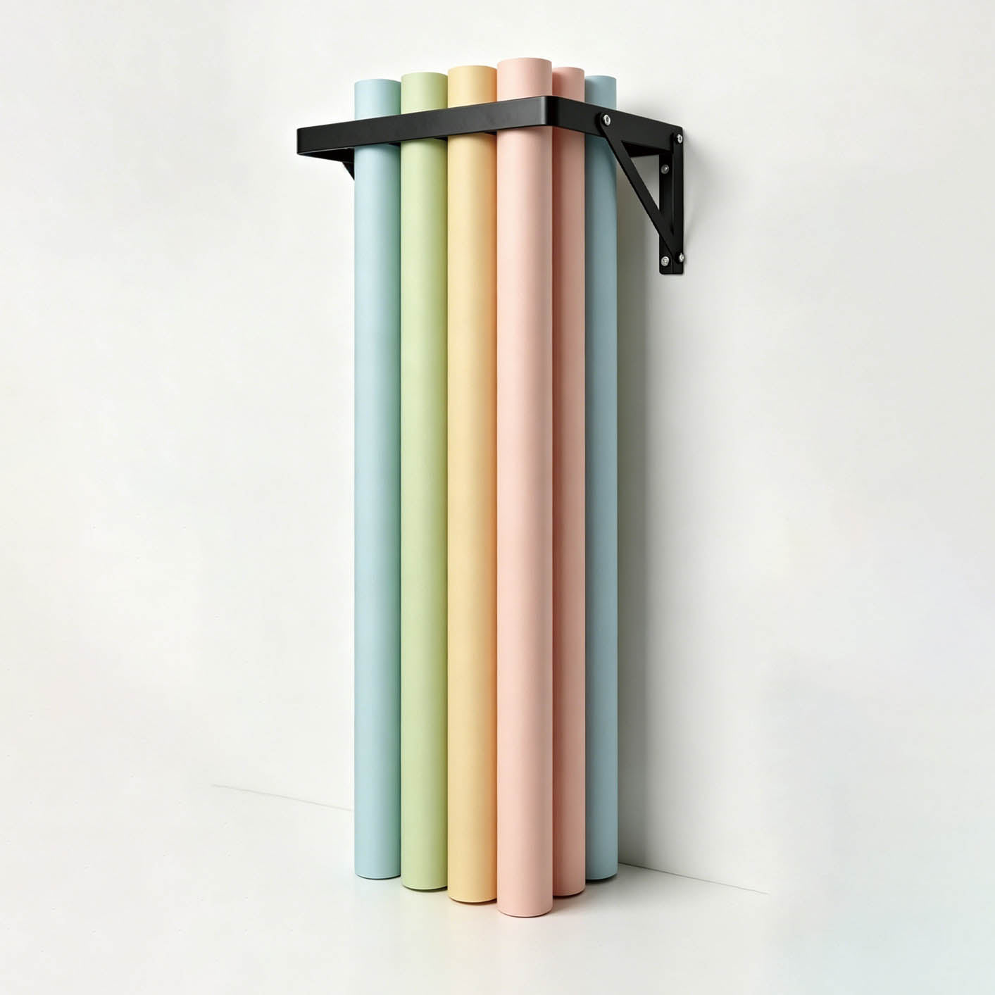 The PiXAPRO Wall-Mounted 12 Seamless Paper Backdrop Roll Storage Rack being used to hold a selection of seamless paper backdrop rolls