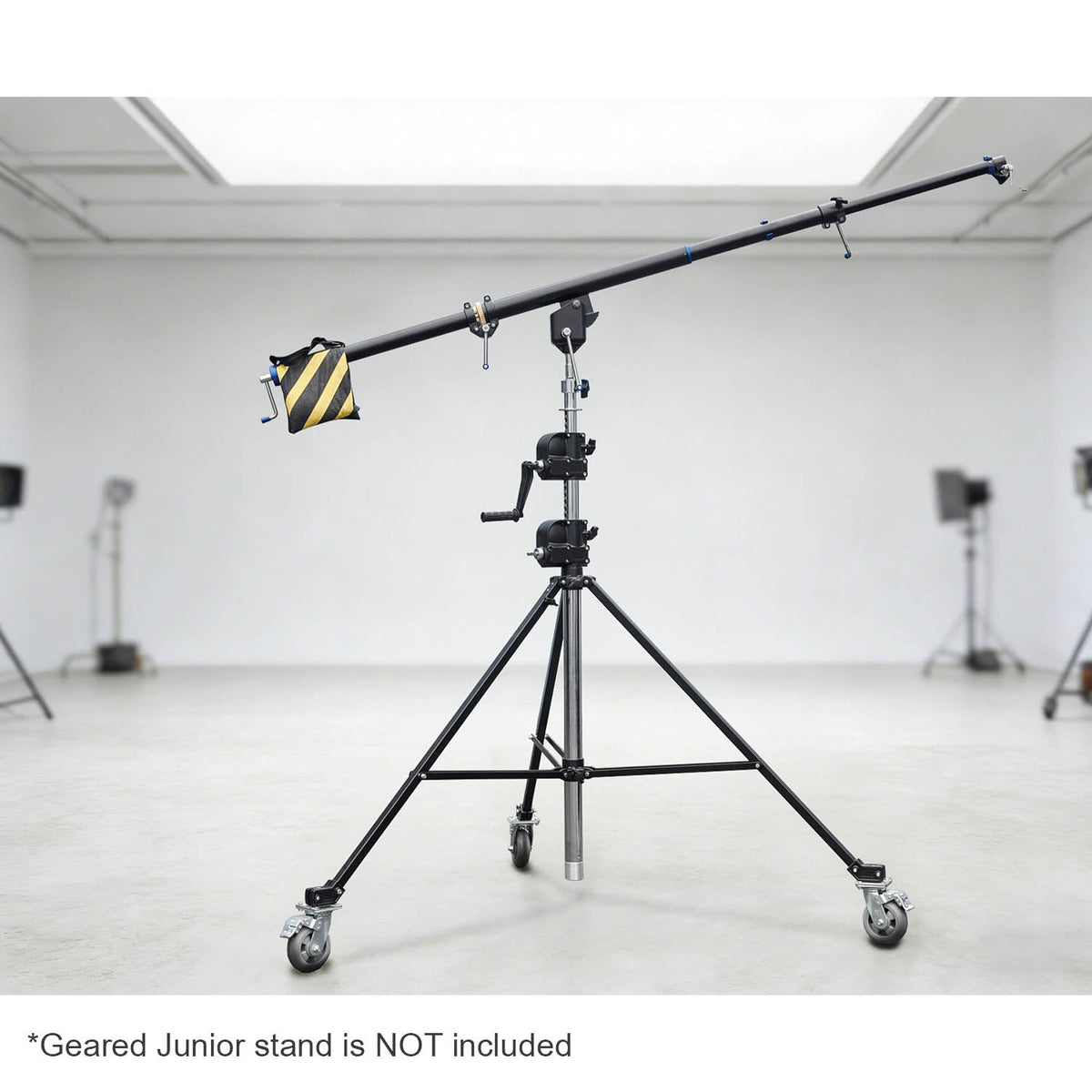 The 216-370 cm Heavy-Duty Geared Junior Boom Crane Arm mounted to a junior geared stand in a large studio environment