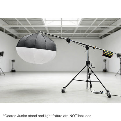 The 222-370cm Heavy-Duty Geared Junior Boom Crane Arm mounted to a junior geared stand with a large lantern mounted to it in a large studio environment