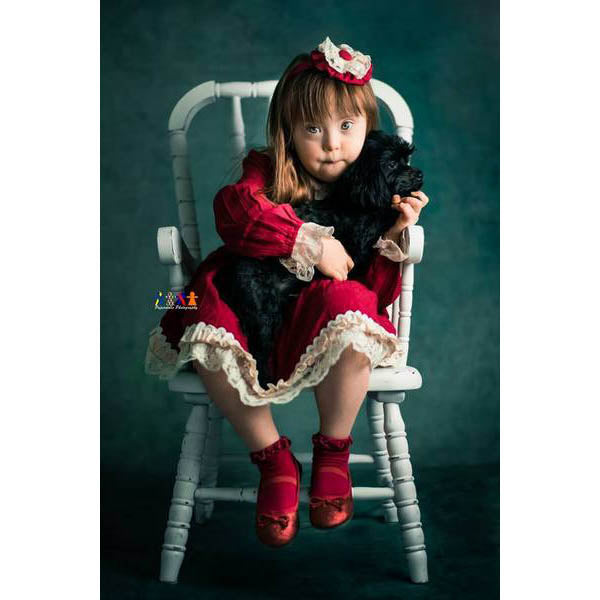 Child in a red dress sitting on a white chair holding a black dog in front of a 3x2m Abstract Texture Fine Art Green tones Horizontal Background from Kate Backdrops