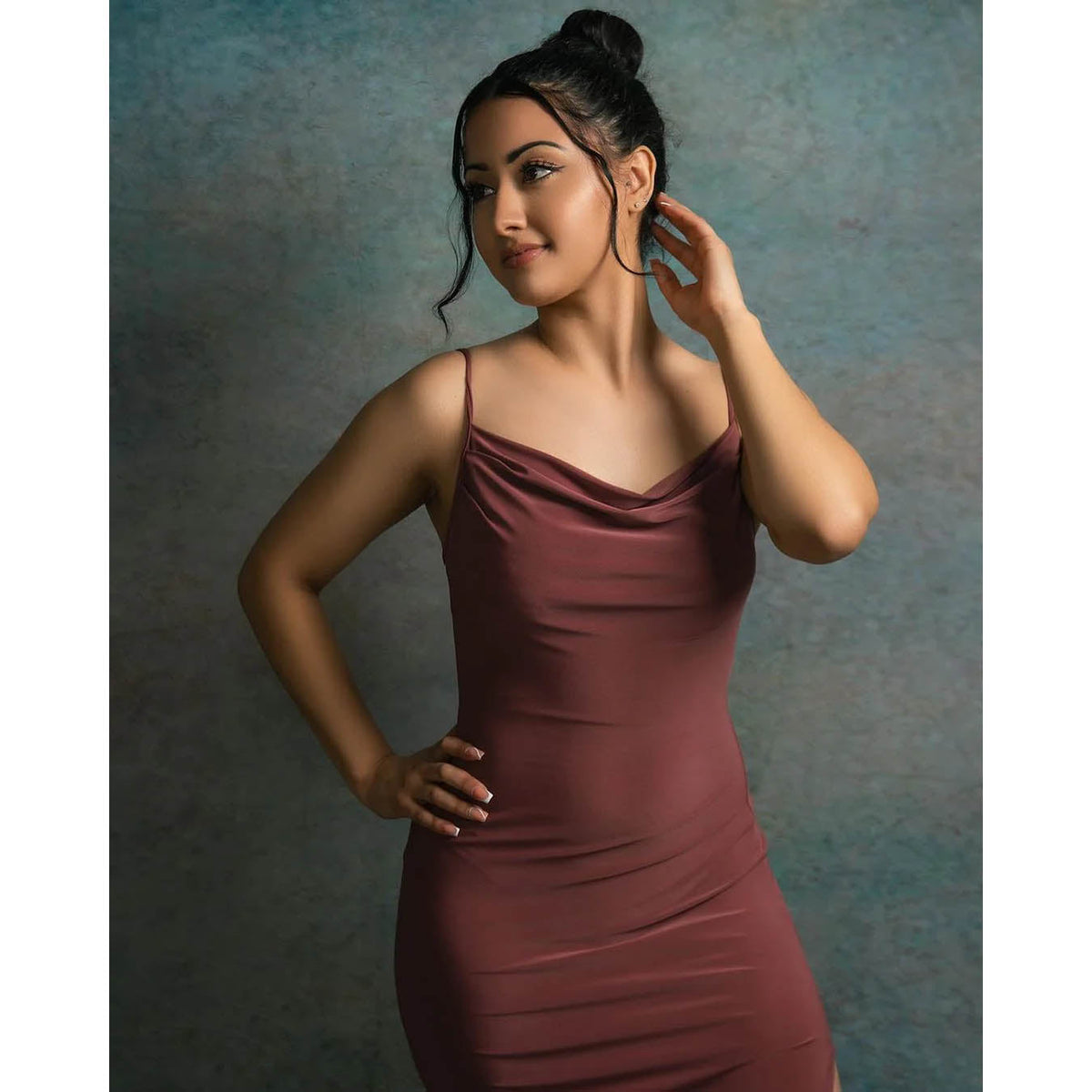 A woman in a burgundy dress is posing against a 2x3 Abstract Rusty Texture Studio Photography Background by Kate Backdrops