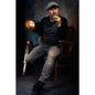 A man sitting on a wooden chair in a dimly lit room with a vintage lamp in front of a 2x3 Abstract Background Texture Studio Photography Background By Kate Backdrops