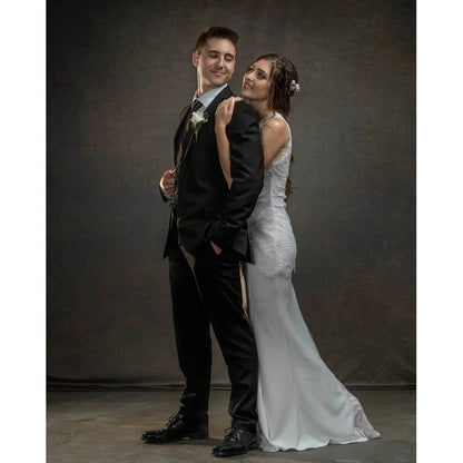 Man in a suit and a woman in a wedding dress embracing against a Kate Backdrops 2x3 Dark Grey Brown Mixed Green Abstract Texture Studio Photography Backdrop