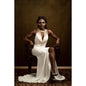 A lady in a dress wearing FX makeup sitting in front of a 3x2m Dark Gold Abstract Horizontal Backdrop 