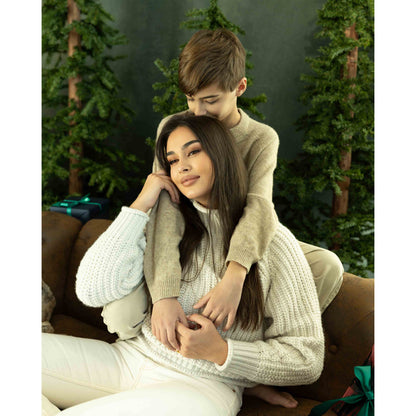 A Lady and a young boy sitting on a brown leather sofa in front of a Abstract Olive Green Textured Studio Photography Backdrop