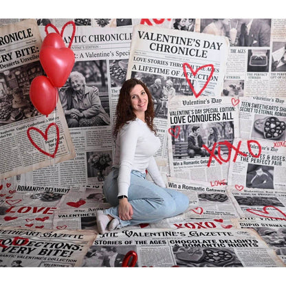A woman sitting on a Valentine's Day Newspaper Love Hearts Backdrop 