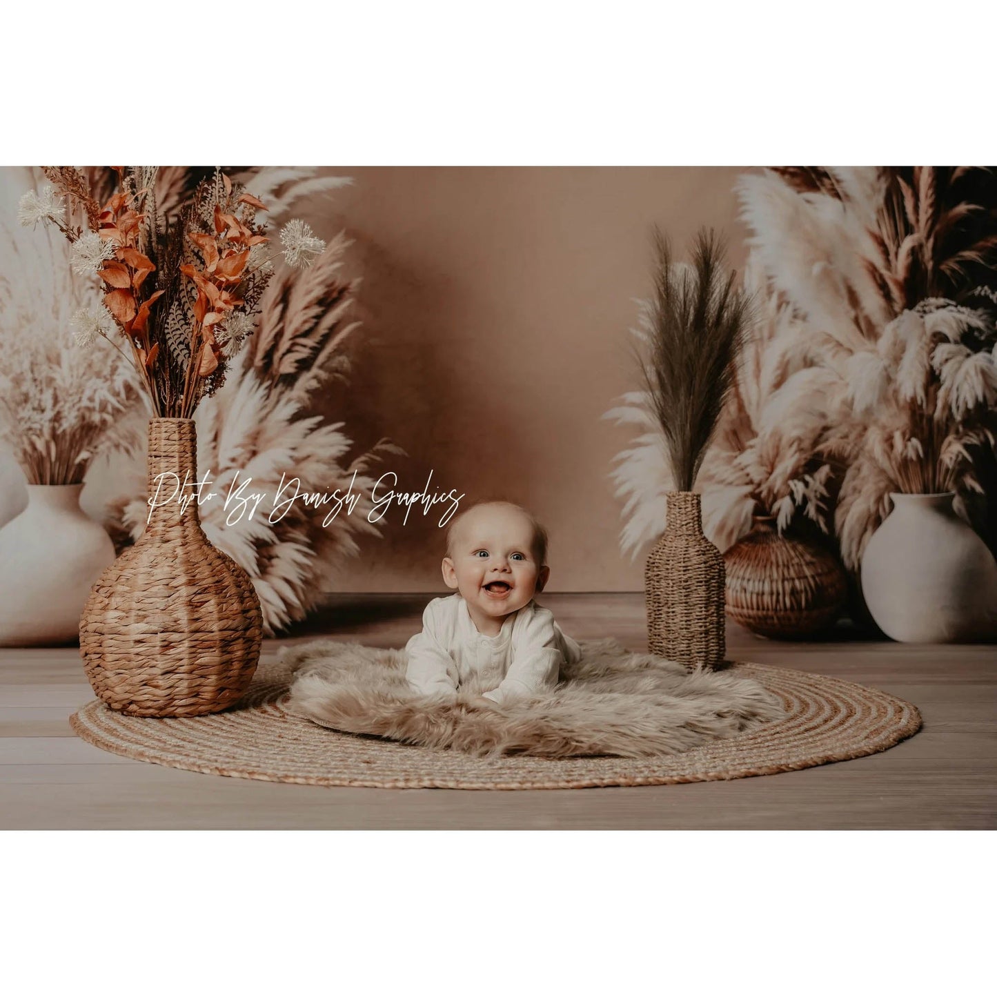 A baby sting in front of a Sweep Boho Floral Arch Beige Backdrop