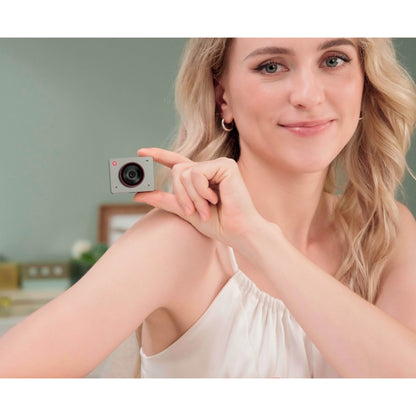 A lade holding an OBSBOT MEET 2 Webcam